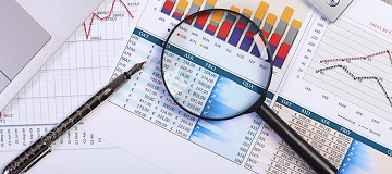 Magnifying glass and pen on statistics form