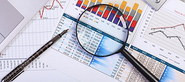 Magnifying glass and pen on statistics form