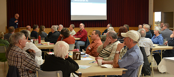 Warden speaking to group of citizens