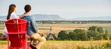 Couple viewing valley vista from lawn chair