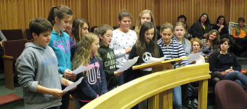 Children reading in front of council