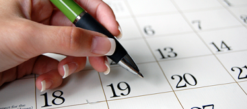 Pen hovering over calendar