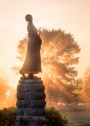 Evangeline statue with sunshine rays behind